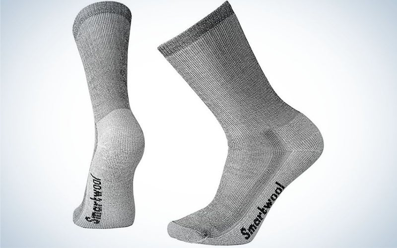 Two pair of socks in a grey color with written letters under them.